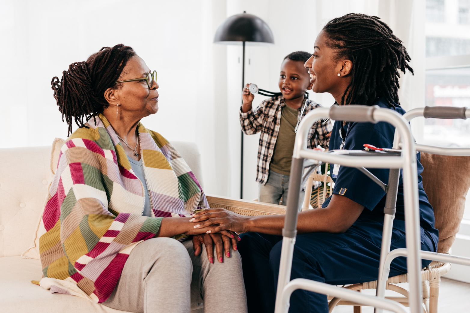 A caregiver warmly visiting a client at home