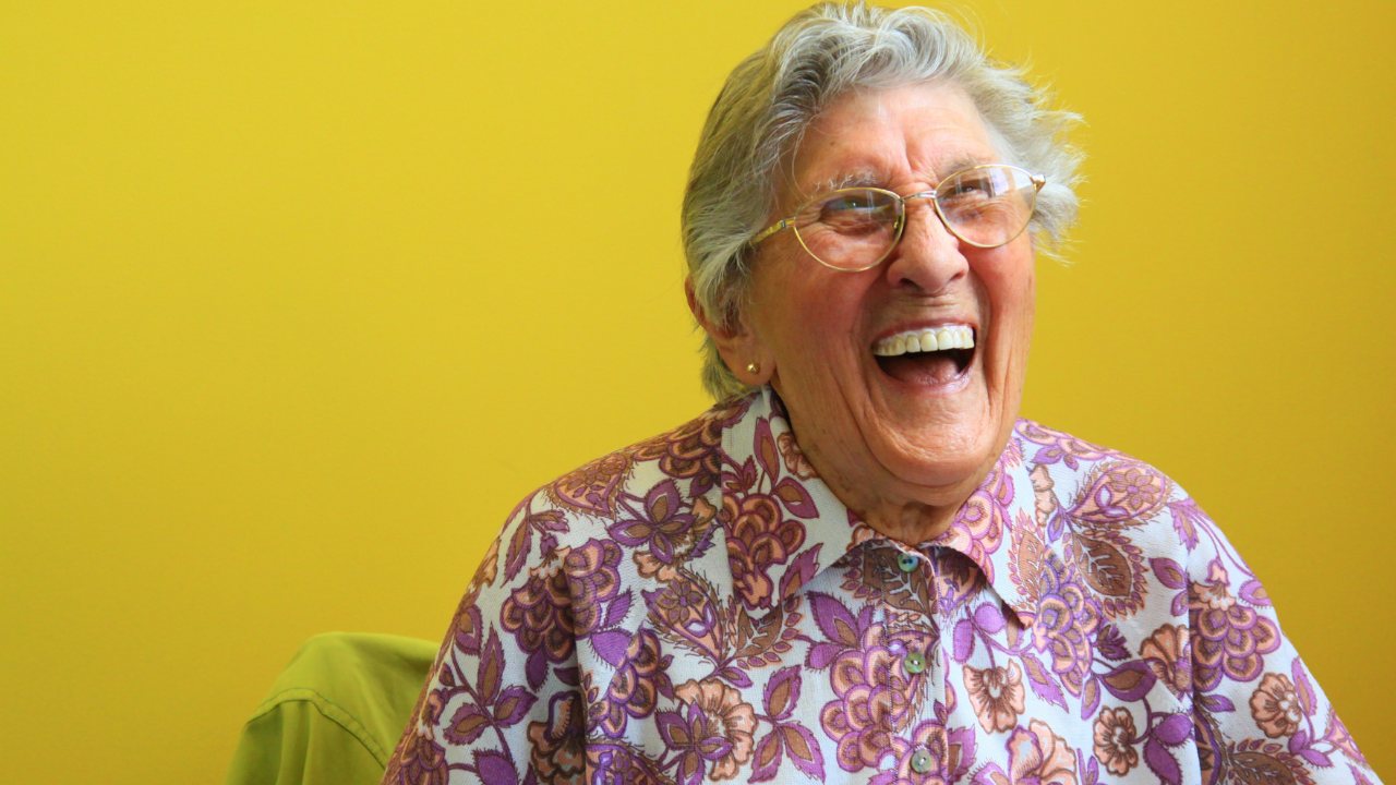 A senior woman laughing